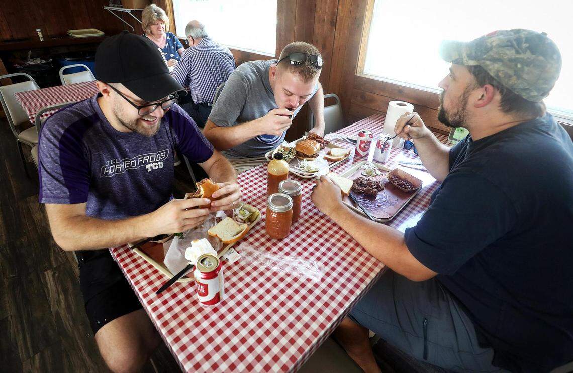 Andrew Makquilkan, left, Zach Roebuck, center, and Taylor Massey have lunch at GoldeeÕs BBQ on Friday, October 15, 2021, in Kennedale.