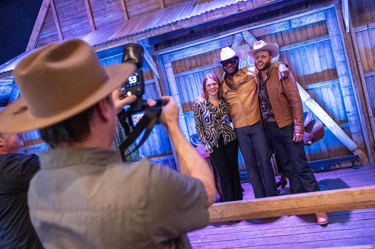 Musician Leon Bridges, left, Indie-music artist Maggie Rogers, middle, and Country music artist Charlie Crockett are photographed together at ‘The Big Good’s annual fundraiser ‘The Big Night’ at the River Ranch Stockyards in Fort Worth on Thursday, April 3, 2025.