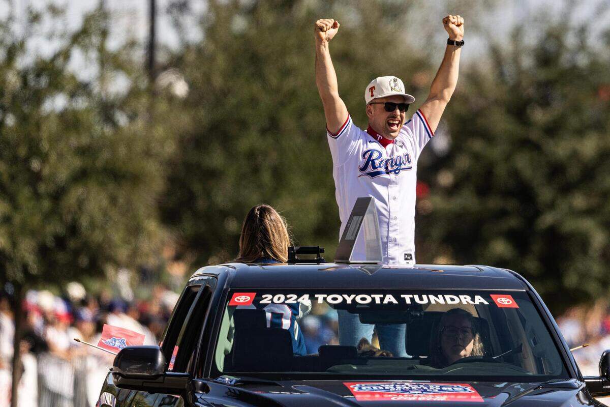 Rangers first baseman Nathaniel Lowe celebrates with the crowd for the World Series Parade in front of Globe Life Field in Arlington on Friday, Nov. 3, 2023.