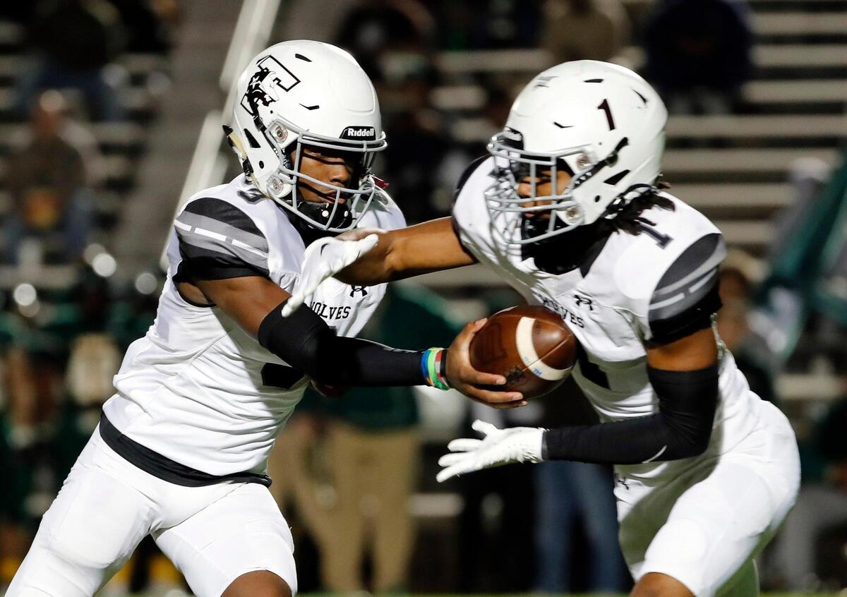 Timberview quarterback Cameron Bates (3) hands the ball to running back Jarvis Reed (1) n the first half of a UIL Class 5A D1 Region 2 final football game at Mesquite Memorial in Mesquite, Texas, Friday, Dec. 02, 2022. The score was knotted14 at the half. (Special to the Star-Telegram Bob Booth)