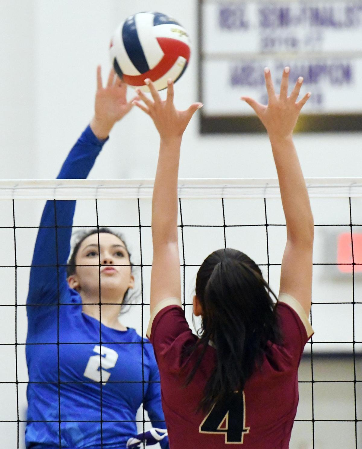 Boswell’s Peighton Serda, left hits the ball over Saginaw’s Sidney Jones in game one of their volleyball match Thursday, September 15, 2020 in Boswell, Texas. Boswell went on to win the match 25-17, 25-8, 25-8. Special/Bob Haynes