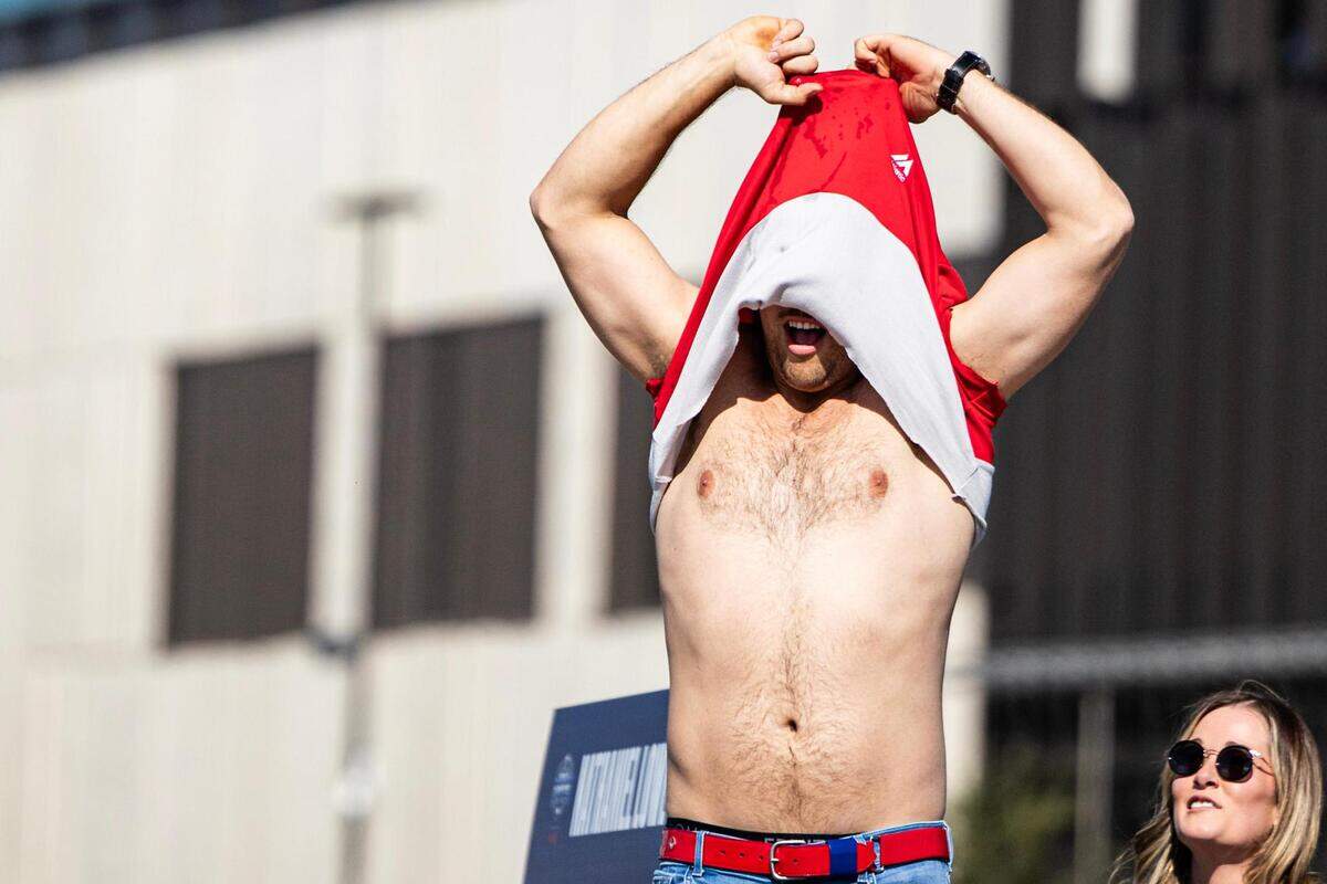 Rangers first baseman Nathaniel Lowe takes his shirt off and celebrates with the crowd for the World Series Parade in front of Globe Life Field in Arlington on Friday, Nov. 3, 2023.