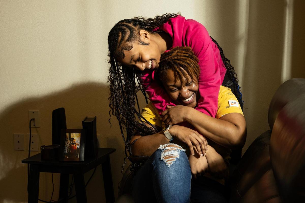 Smith and her youngest daughter La’Nisha in the living room of their new home in Fort Worth. The family had spent years moving from rental to rental before settling in the house.