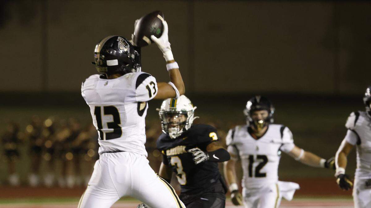 Eagle Mountain defenisve back Kathen Middleton (13) intercepts a ball intended for Benbrook wide receiver DeShawn Deane (3) during the first half of a UIL football game between Eagle Mountain and Benbrook at Farrington Field in Fort Worth, Texas, Friday, Sept. 26, 2025.