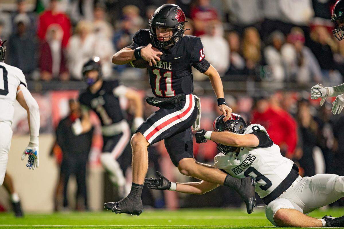 Argyle quarterback Maguire Gasperson keeps the ball against Colleyville Heritage in a playoff game.
