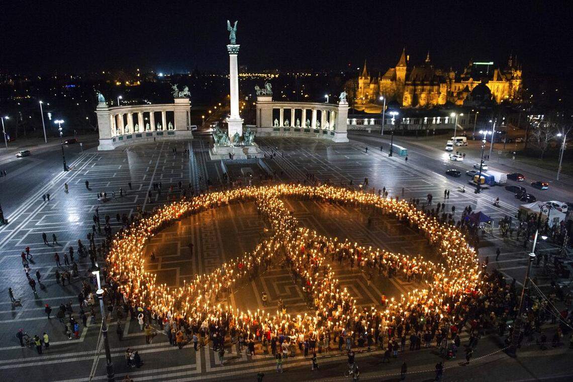 People create a peace sign with lights as a demonstration for Ukraine at Heroes Square in Budapest, Hungary organized by Greenpeace on Wednesday, March 9.