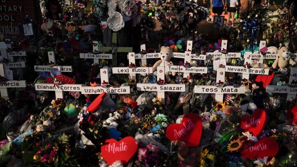 Flowers are piled around crosses with the names of the victims killed in last week’s school shooting as people visit a memorial at Robb Elementary School to pay their respects, Tuesday, May 31, 2022, in Uvalde, Texas. (AP Photo/Jae C. Hong)