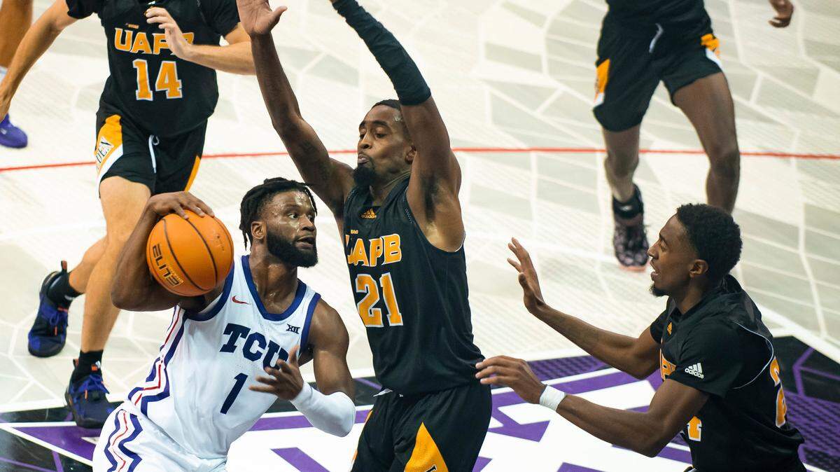 TCU guard Mike Miles Jr. (1) attempts to get around Arkansas-Pine Bluff guard Shaun Doss Jr. (21) in the first half of an NCAA college basketball game in Fort Worth, Texas, Monday, Nov. 7, 2022. (AP Photo/Emil Lippe)
