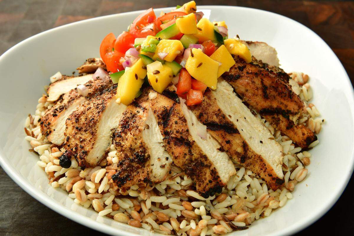 African-spiced SuperGrain Bowl at AT&T Stadium: brown rice, barley and farro topped with savory dukkah chicken and a fresh mango cucumber salsa. Can be ordered without the chicken for a vegetarian option.