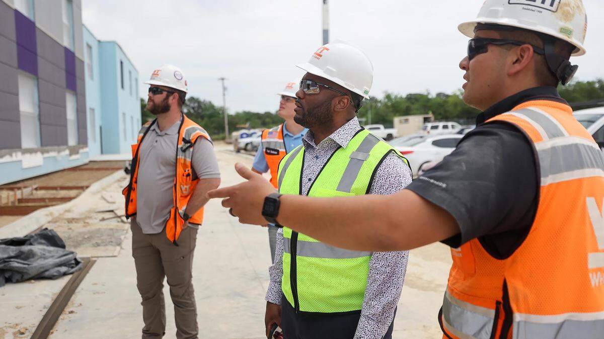Andrew Lou, field engineer for Whiting-Turner Contracting Company, right, shows SaJade Miller, center, the progress being made at the site of the future Rocketship Dennis Dunkins Elementary School on Tuesday, May 18, 2022.