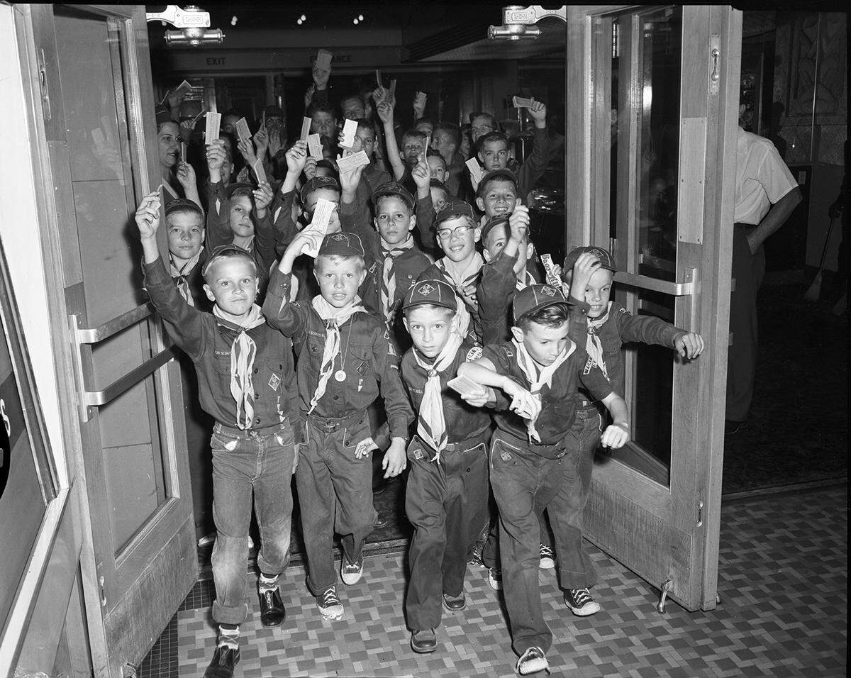 April 22, 1954: A small section of Boy Scouts scurry out of the Worth Theater to start their downtown ticket selling invasion. Tickets are for the scouting in Action Exposition to be held May 7-8 at Will Rogers Exhibit Building. Five hundred scout attended a pep rally before starting the ticket sales. Proceeds aid Worth Ranch.