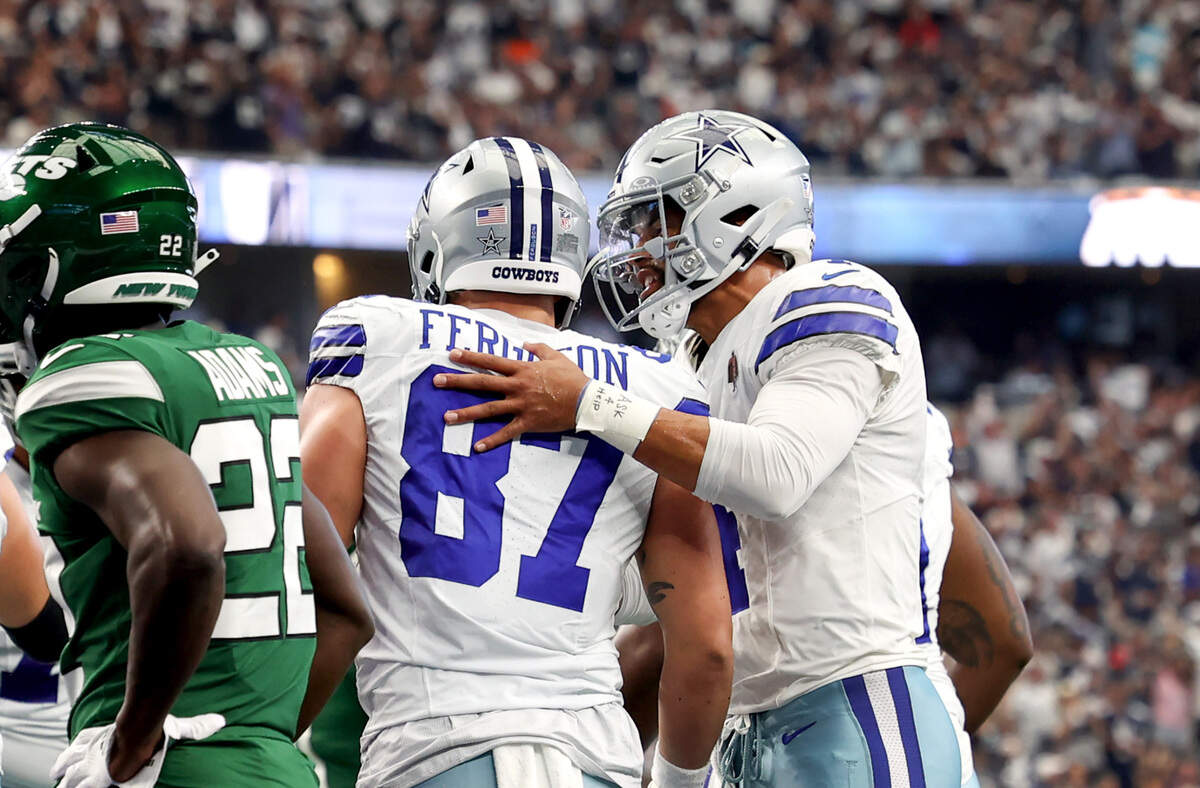 Dallas Cowboys quarterback Dak Prescott celebrates with tight end Jake Ferguson after connecting with him for a touchdown against the New York Jets on Sunday, September 17, 2023, at AT&T Stadium in Arlington.