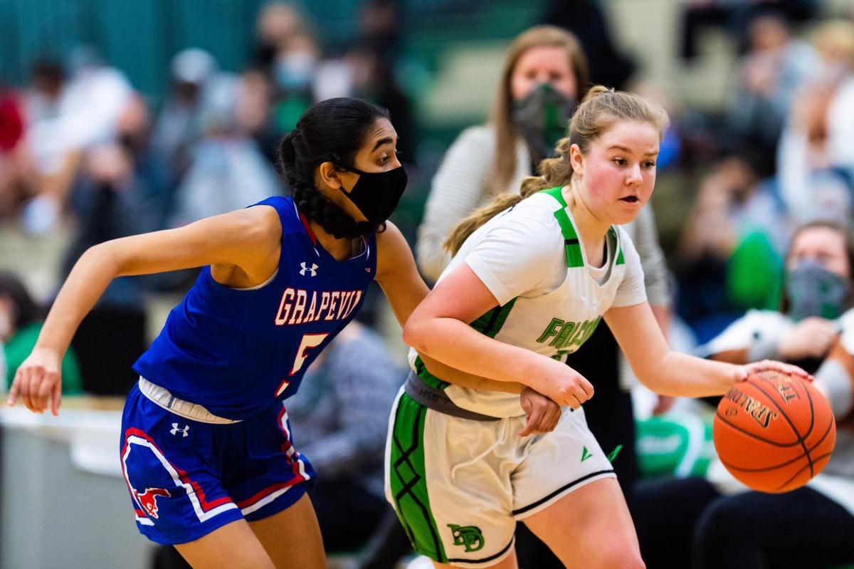 Bailey Broughton (14) dribbles while being guarded by Ami Mangrolo (5) during a district match between Lake Dallas and Grapevine at Lake Dallas High Shcool on January 29, 2021. Photo by Matt Smith (Special to the Star-Telegram).