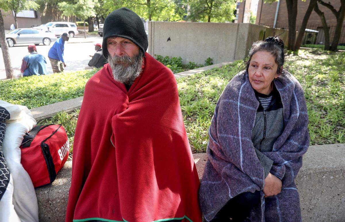 Daniel Busbey, left and Lupe Aldama wait for the Fort Worth Convention Center to open its doors on Tuesday, April 14, 2020. The Convention Center is being used as an overflow shelter for Fort Worth homeless during the coronavirus pandemic.