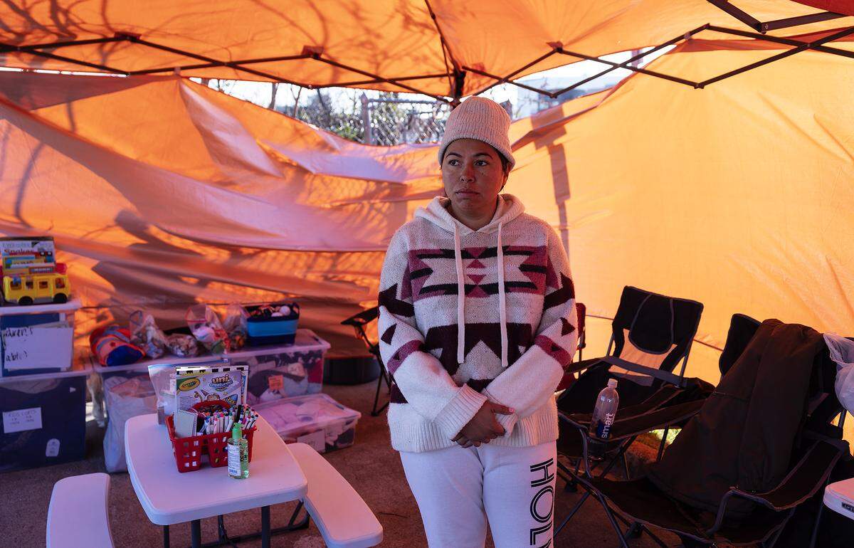 Community organizer Sandra Avalos stands inside what is now as “the tent” outside of the U.S. Immigration and Customs Enforcement field office in Dallas on Friday, Jan. 16, 2026.