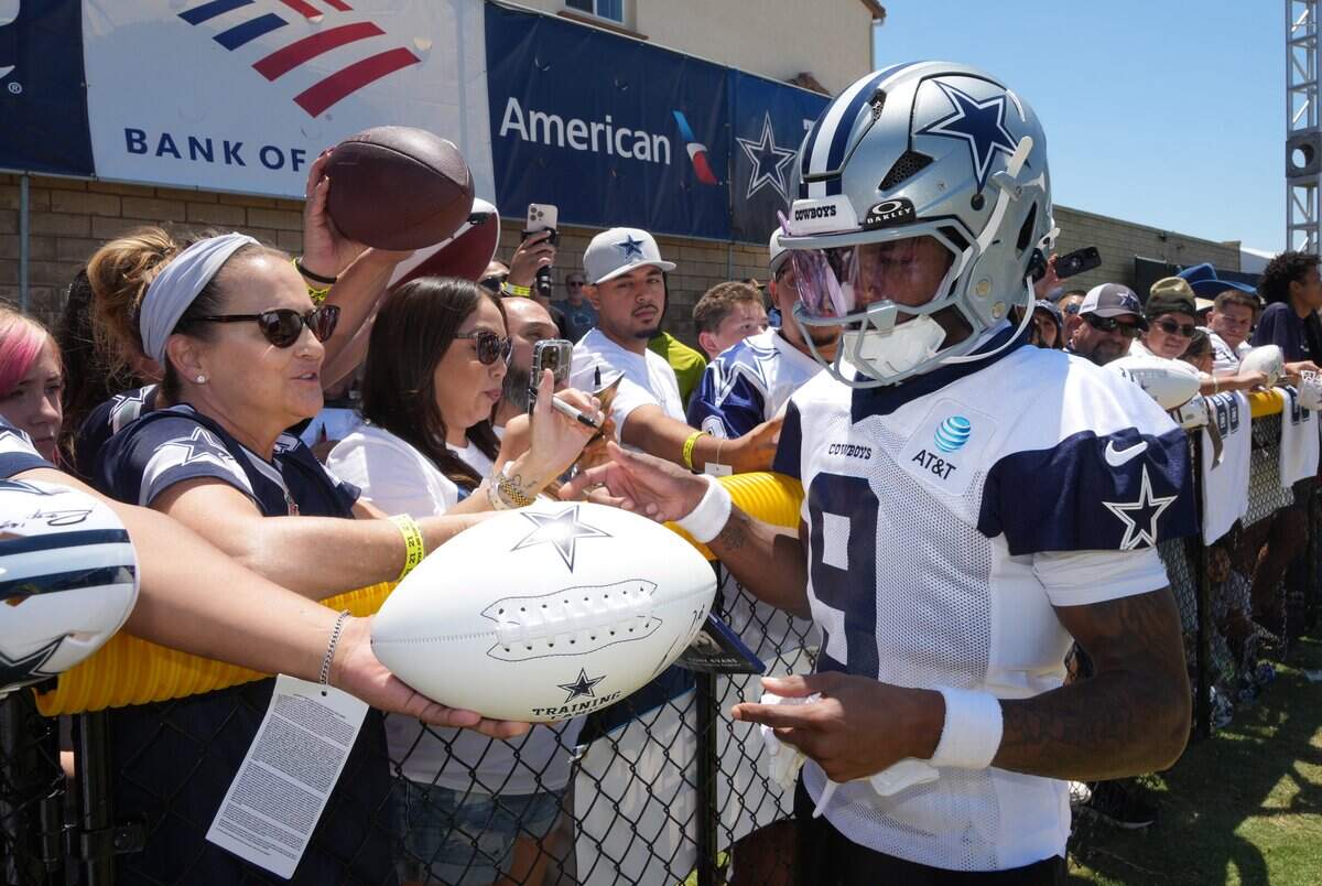 Jul 26, 2025; Oxnard, CA, USA; Dallas Cowboys receiver Kavontae Turpin (9) signs autographs at training camp at the River Ridge Fields. Mandatory Credit: Kirby Lee-Imagn Images