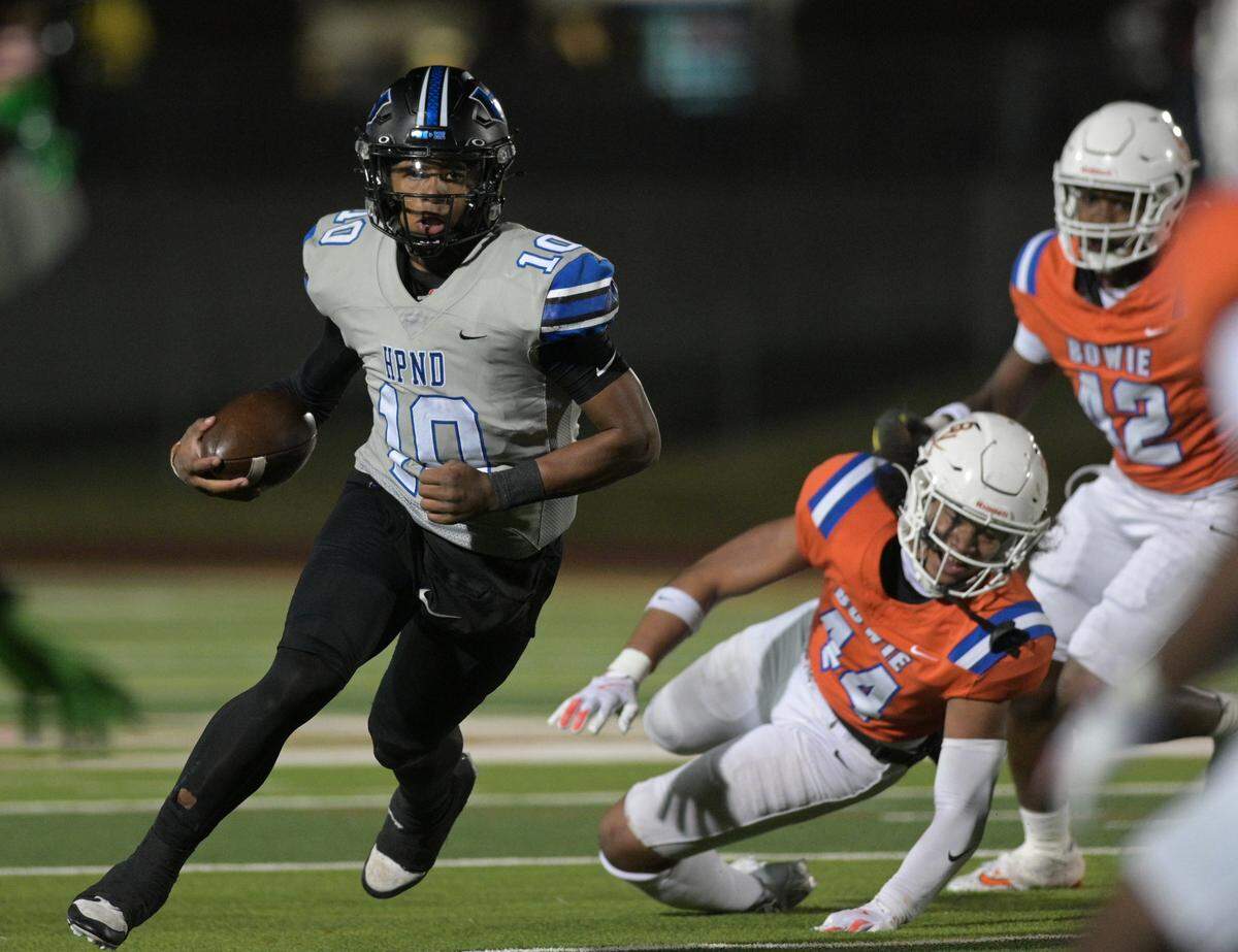 Hebron Hawk quarterback Patrick Crayton Jr. (10) runs past Bowie defenders during a UIL football playoff game against Bowie High School at Mustang-Panther Stadium in Grapevine, Texas on Friday, Nov. 22, 2024.
