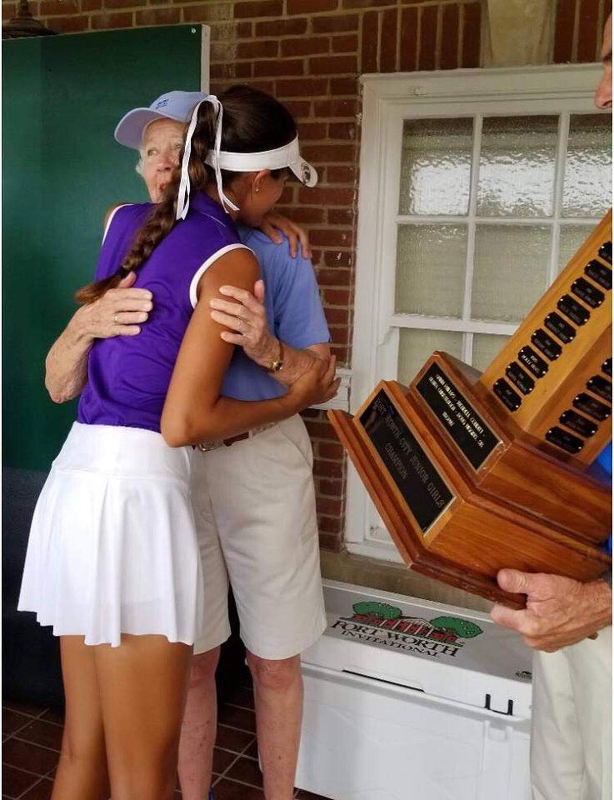 Trinity King hugs Texas Golf Hall of Famer Martha Leonard, whose father founded The Colonial.