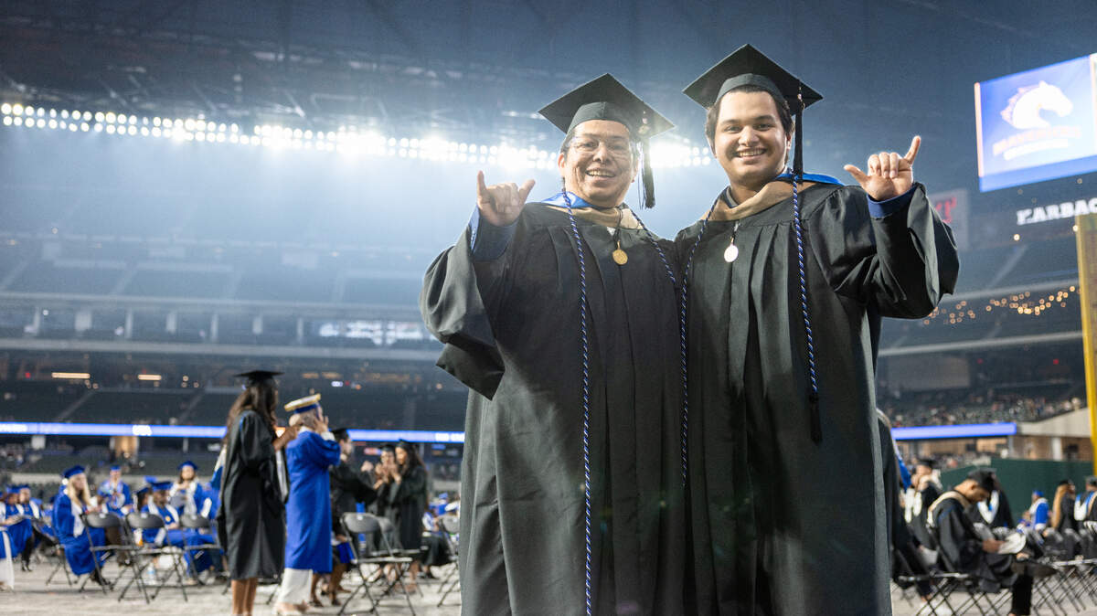 Oswaldo Ortiz Jr. (left) and his father, Oswaldo Ortiz Sr. recently graduated from the University of Texas at Arlington Master of Business Administration program together.