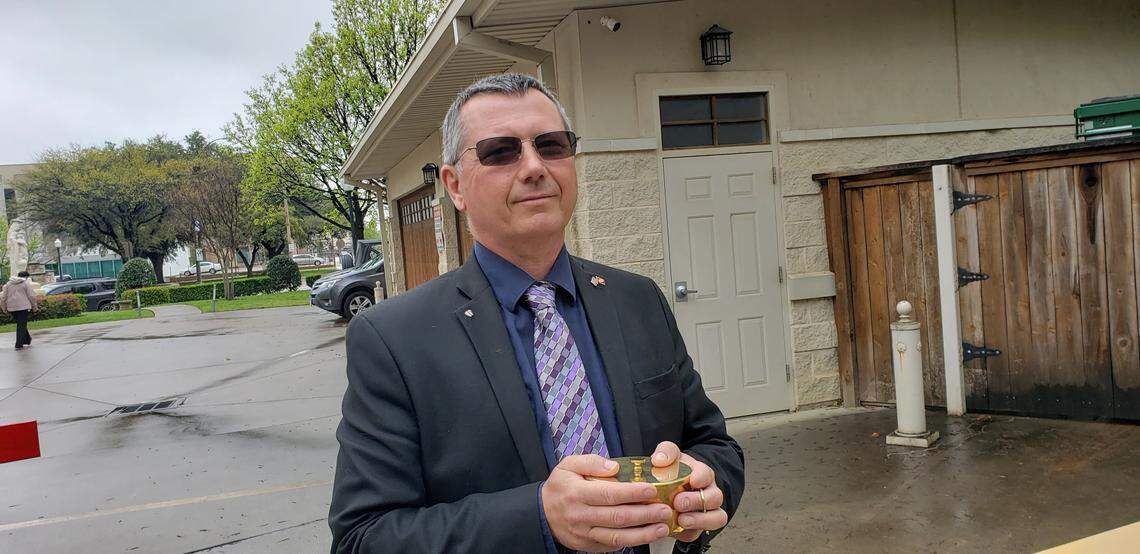 Vincent Booth waits to serve the faithful as they come to receive the sacrament of the Holy Eucharist at St. Patrick’s Cathedral on Sunday.