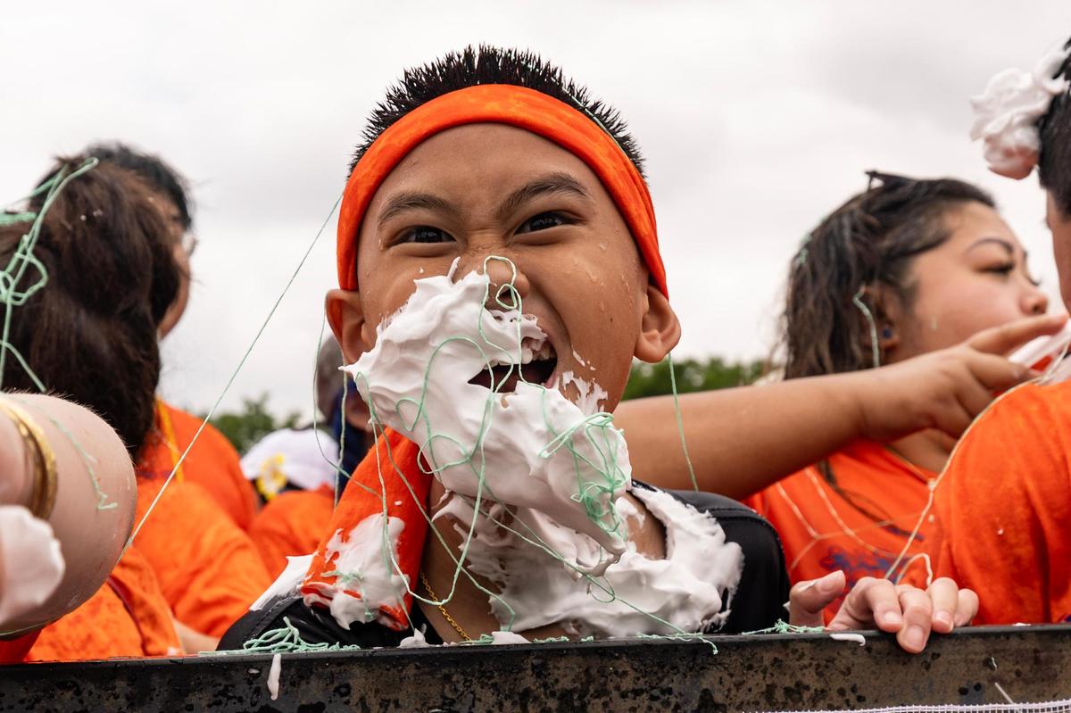 A festival attendee becomes covered in shaving cream during the Lao New Year parade on the third day of the Lao New Year festival at Wat Lao Thepnimith Temple in Saginaw on Sunday, April 27, 2025.