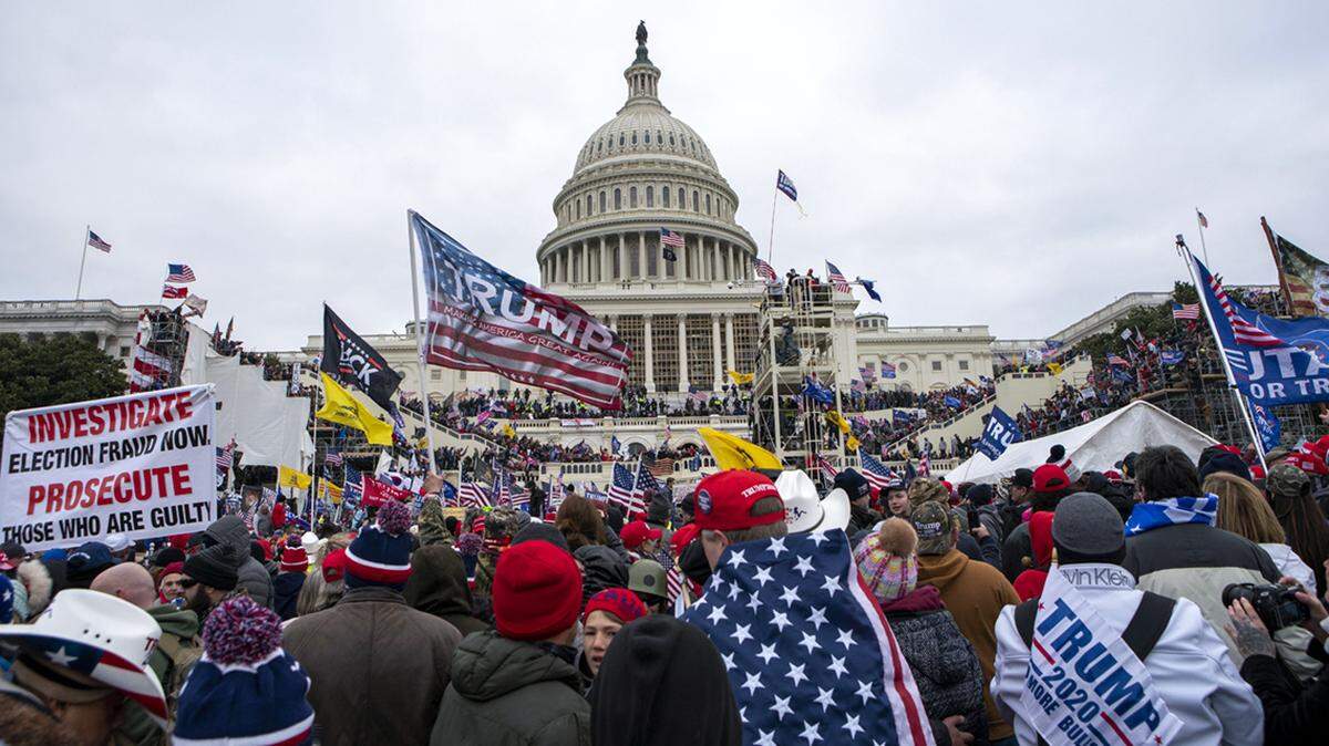 FILE - In this Jan. 6, 2021, file photo insurrections loyal to President Donald Trump rally at the U.S. Capitol in Washington. U.S. Capitol Police officers who were attacked and beaten during the Capitol riot filed a lawsuit Thursday, Aug. 26, against former President Donald Trump, his allies and members of far-right extremist groups, accusing them of intentionally sending insurrectionists to disrupt the congressional certification of the election in January. (AP Photo/Jose Luis Magana, File)