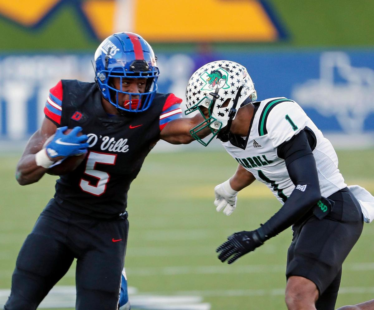 Duncanville running back Malachi Medlock (5) gains yards against Southlake defensive back Avyonne Jones (1) during a high school Class 6A Division 1 semifinal playoff game at McKinney ISD Stadium in McKinney, Texas, Saturday, Dec. 11, 2021. Duncanville led Southlake Carroll 21-3 at the half. (Special to the Star-Telegram Bob Booth)