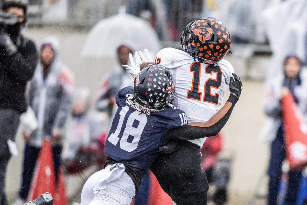 Aledo receiver Lincoln Tubbs (12) makes a long catch as Denton Ryan’s Byran Simmons (18) defends in a Class 5A Division 1 state quarterfinal on Saturday, Dec. 7, 2024 at Crowley ISD Multi-Purpose Stadium in Fort Worth, Texas.
