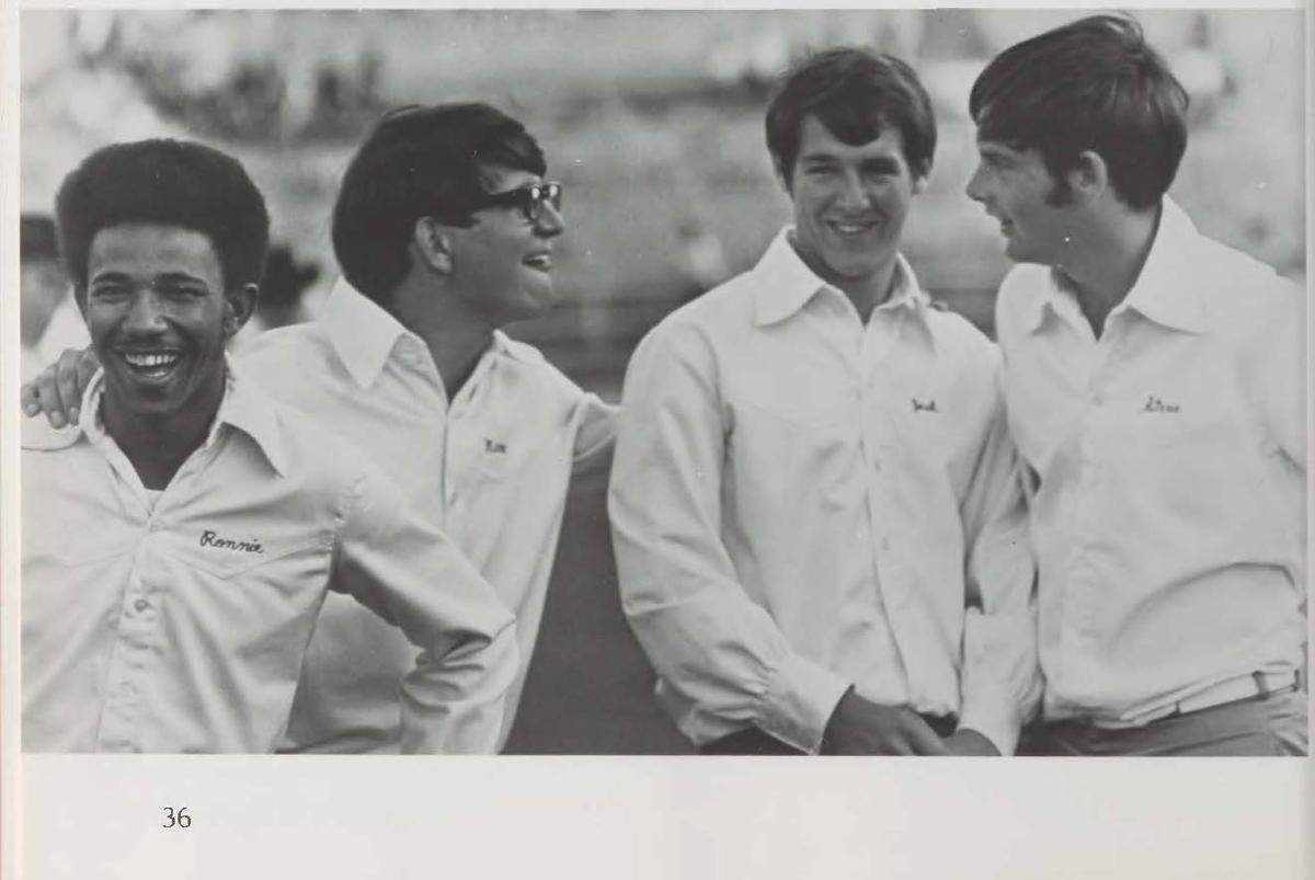 Ron Hurdle, left, laughing with friends, in this file photo. Hurdle was the first Black cheerleader at TCU.
