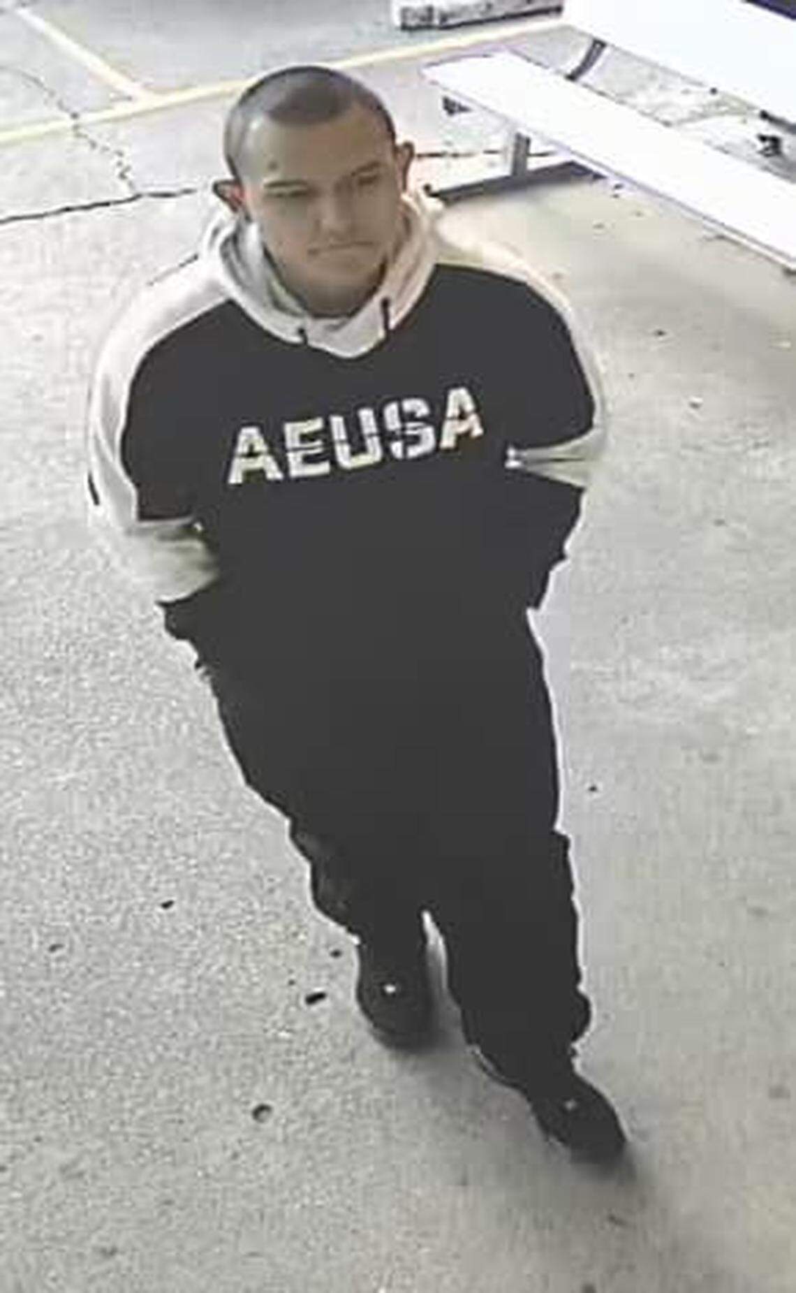 Irving police released surveillance photos of a man accused of robbing a pregnant cashier at a restaurant Friday.