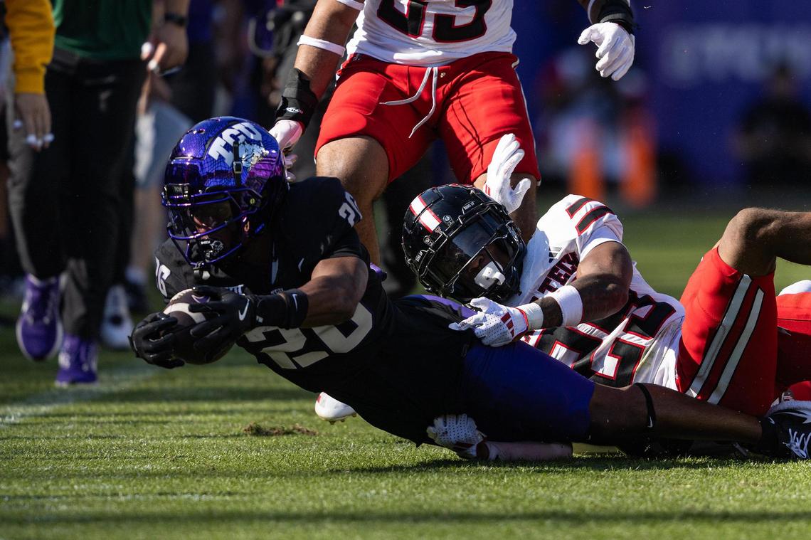 TCU running back Jeremy Payne (26) dives for the first down while being tackled by Texas Tech defensive back Peyton Morgan (28) in the first half of an NCAA football game between TCU and Texas Tech at Amon G. Carter Stadium in Fort Worth on Saturday, Oct. 26, 2024.