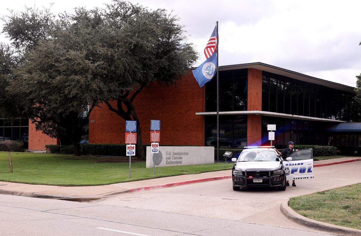 A Dallas police officer in front of the Immigration and Customs Enforcement facility in Dallas on Wednesday, Sept. 24, 2025, where a shooting killed at least one detainee and injured two.