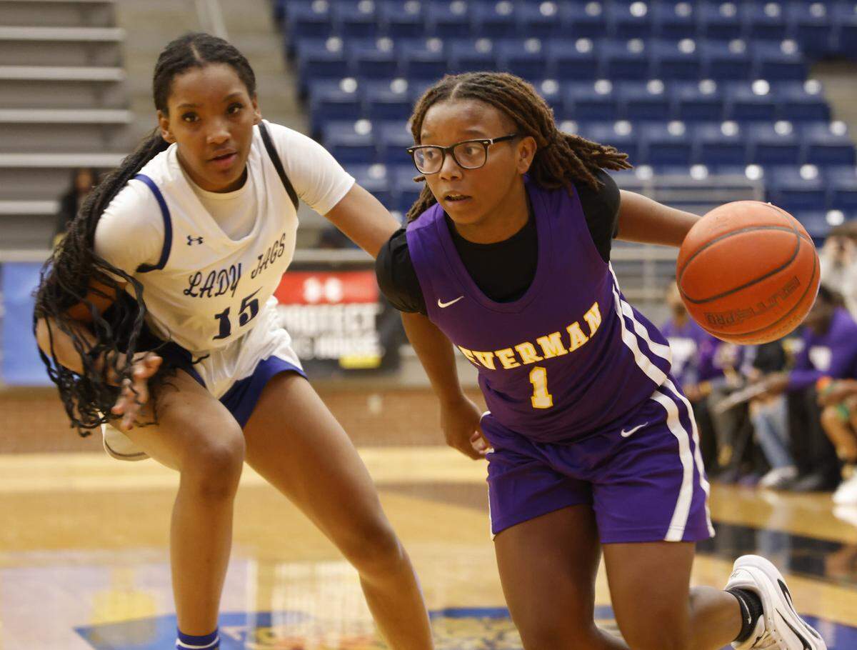 Everman shooting guard Makhiya Dangerfield (1) drives the ball on Mansfield Summit shooting forward Zamyrah Agee (15) during the first half of a UIL girls basketball game between Everman and Mansfield Summit at Summit High School in Mansfield, Texas, Thursday Jan. 22, 2026