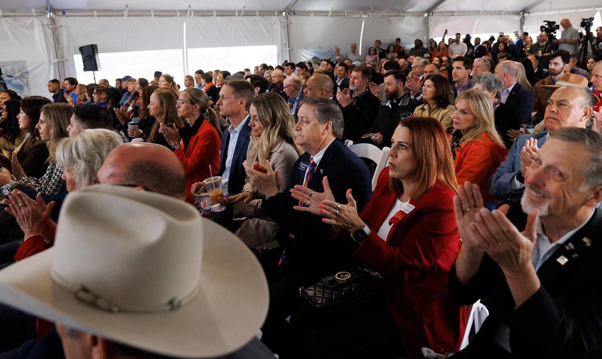 Attendees, UTA officials, local government dignataries, and business leaders among them, applaud during speeches at the groundbreaking for the new UTA West campus on Thursday.