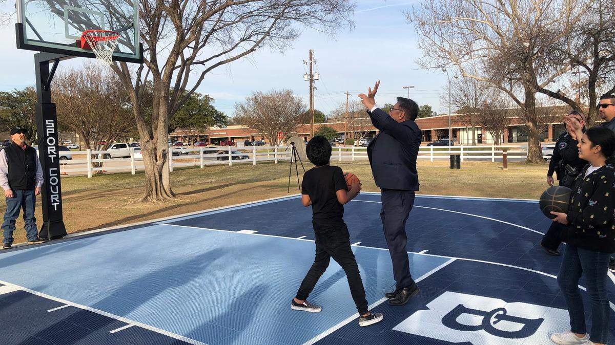Bedford Mayor Michael Boyter shoots some hoops on the new basketball Dream Court in Central Park. Nancy Lieberman Charities and Covenant Church in Colleyville donated the court to the city.