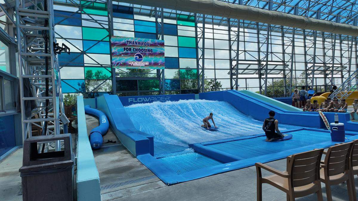 An Epic Water’s visitor is learning how to surf on the Flow Rider at the indoor water park on Wednesday, June 18, 2025 in Grand Prairie.