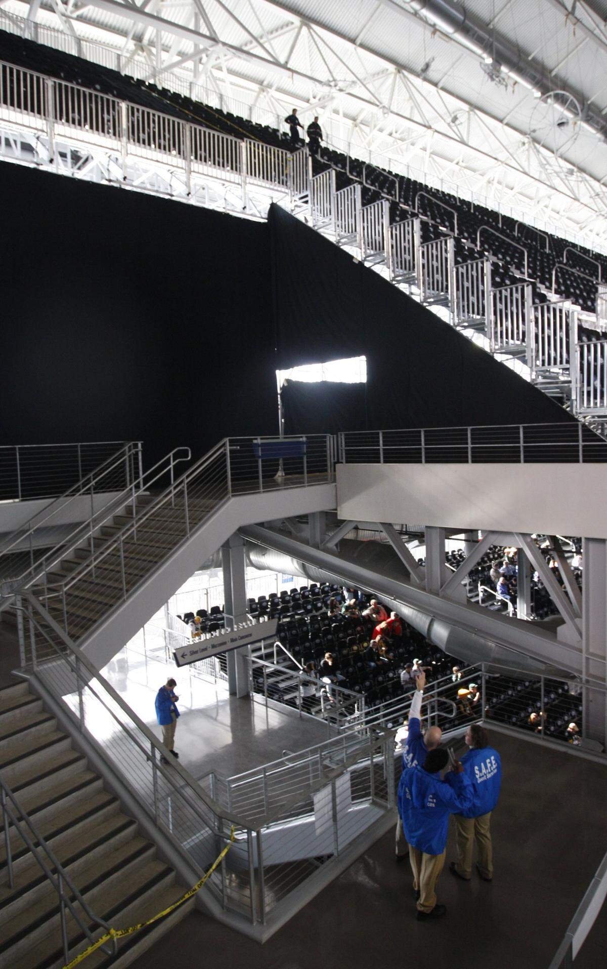 Stadium safety officials stand at the bottom of a cordoned-off section of seats before Super Bowl XLV at Cowboys Stadium Sunday, February 6, 2011,  in Arlington, TX. Not all fans who bought seats for the game were allowed to sit in them. Star-Telegram/Richard W. Rodriguez