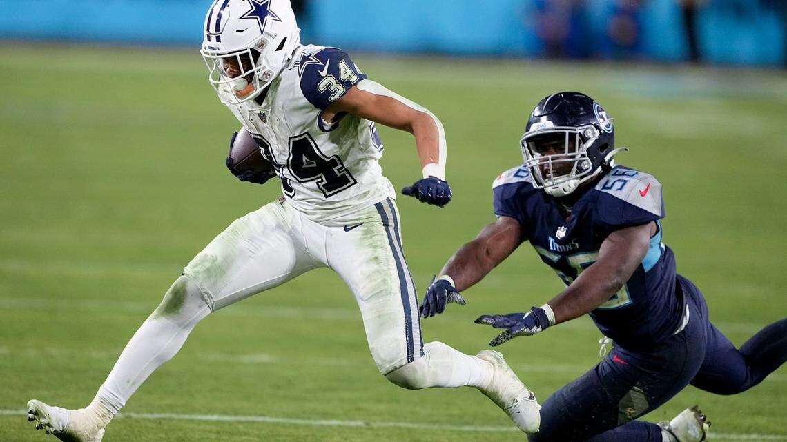 Dallas Cowboys running back Malik Davis (34) runs near Tennessee Titans linebacker Monty Rice (56) during the second half of an NFL football game, Thursday, Dec. 29, 2022, in Nashville, Tenn. (AP Photo/Chris Carlson)