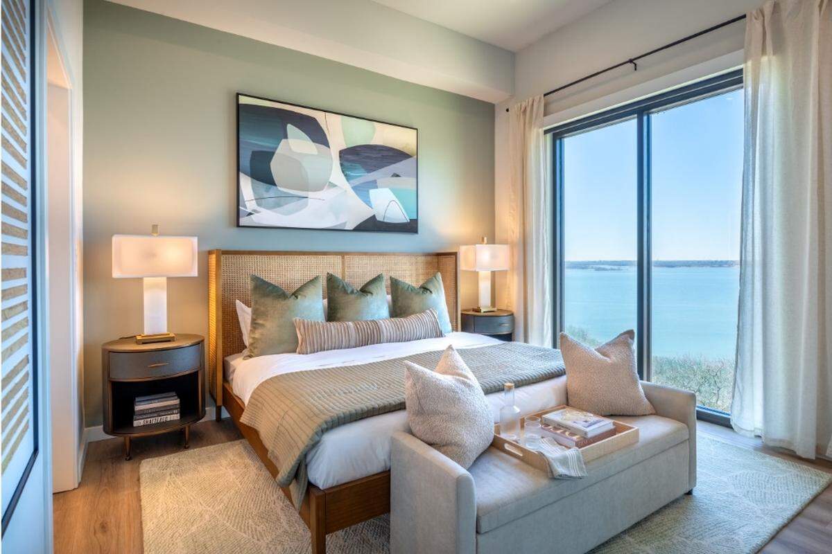 The primary bedroom in a unit at Thirty-One Eleven Sunset, a 16-story, 207-unit luxury residential apartment tower overlooking Lake Grapevine in Flower Mound. 