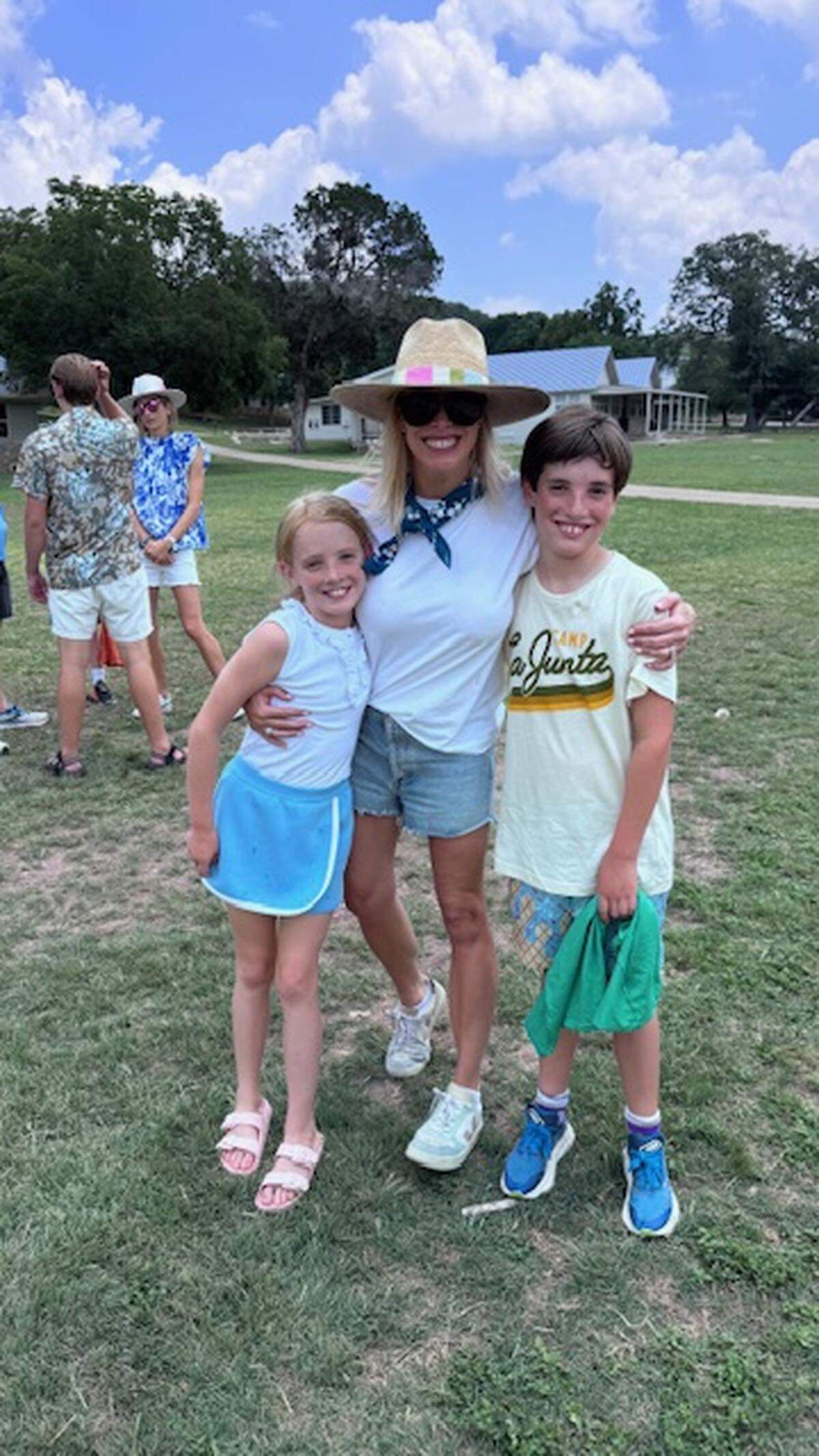Corrigan and Cannon Camp, 9-year-old twins from Fort Worth, pose with Tweety Eastland, one of Camp Mystic’s co-owners and co-directors, in June 2025. Cannon attended the nearby Camp La Junta.