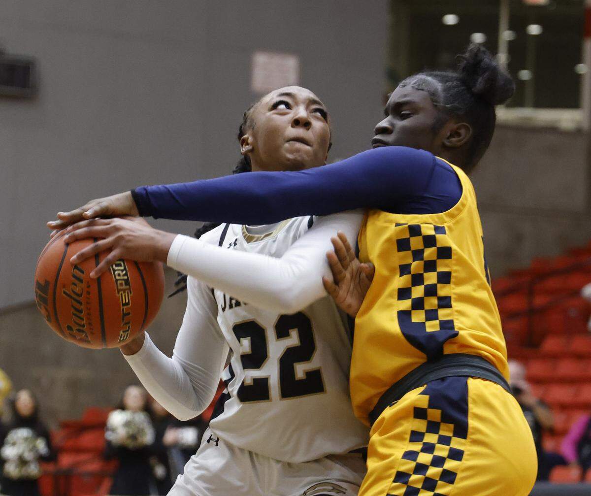 Arlington Heights forward Aliyan Thompson (24) attempts to block the shot of Cleburne guard Arajai Burks (22) during the first half of the UIL 5A D1 girls bi-district championship basketball game at Wilkerson Greines Activity Center in Fort Worth, Texas, Monday Feb. 16, 2026.