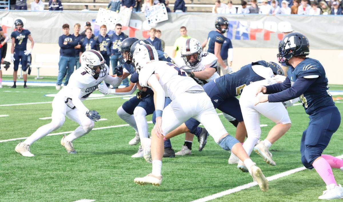 Fort Worth Covenant Classical’s Malachi Brown (2), center, Hudson Williams (8), left, and Jack Nave (21) surround Huntsville Alpha Omega running back Lukas Collier in the TAPPS Six-Man Division II Championship game on Thursday, Dec. 5, 2024 at Waco ISD Stadium in Waco, Texas.