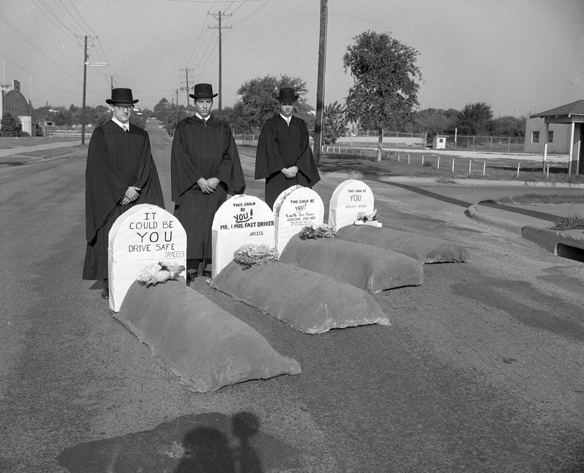 Aug. 29, 1958: Fort Worth Jaycees brought out black robes and mock graves with headstones at reminders of safe driving during Labor Day weekend. Left to right, Lowell Dushman, Charles Deason and Don Tate.