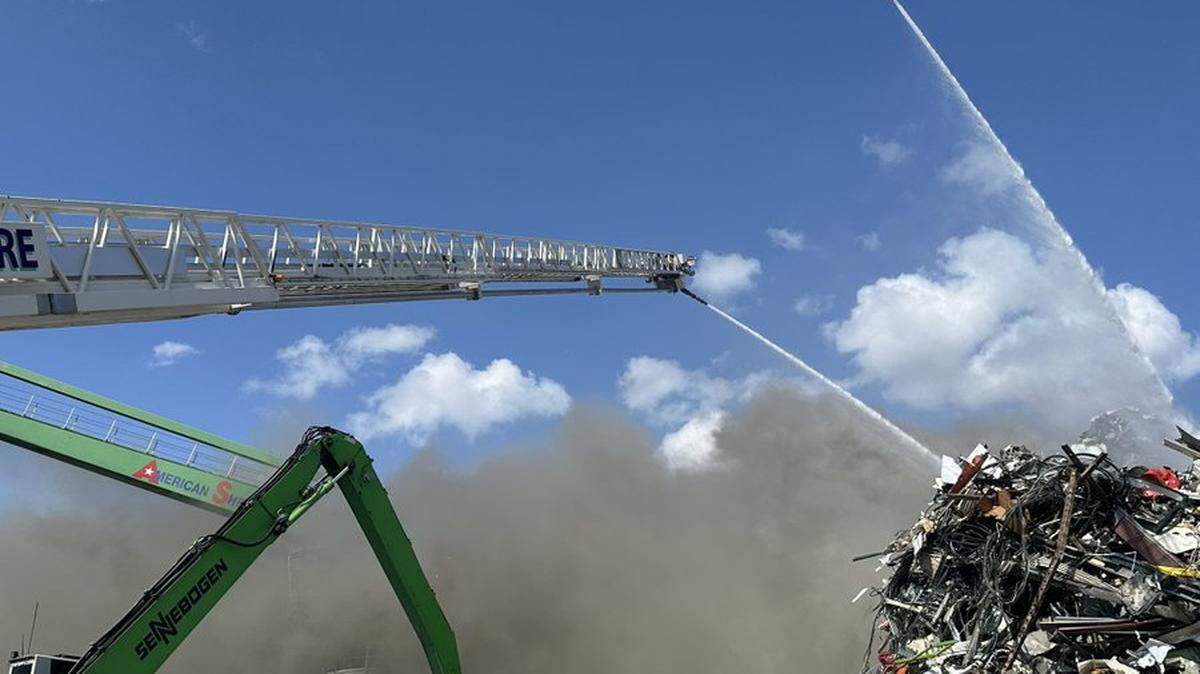 Fire trucks respond to a commercial working fire at Texas Industrial Scrap Iron, a metal recycling business in North Fort Worth on Friday, June 20, 2025.