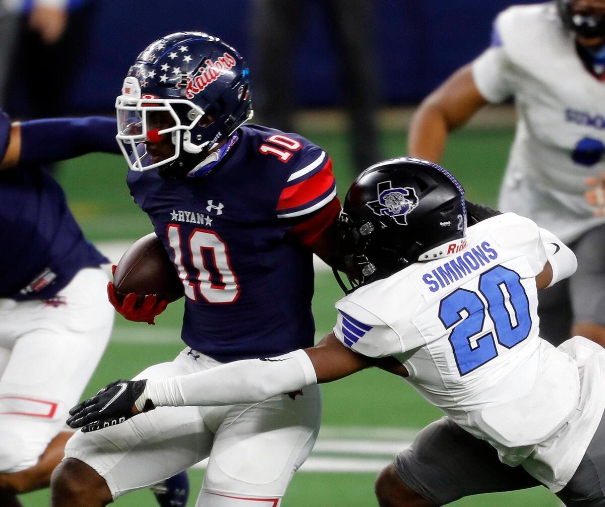 Summit cornerback James Simmons (20) brings down Denton Ryan running back Kalib Hicks (10) in the middle of the field during the Conference 5A Division 1 2020 state championship semi-final football game at AT&T Stadium in Arlington, Texas, Friday, Jan. 08, 2021. Ryan led Summit 21-13 at the half. (Special to the Star-Telegram Bob Booth)