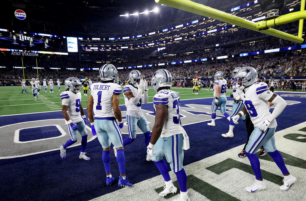 Dallas Cowboys wide receiver George Pickens (3) celebrates a touchdown with teammates during the second half against the Green Bay Packers on Sunday, Sept. 28, 2025, at AT&T Stadium in Arlington.