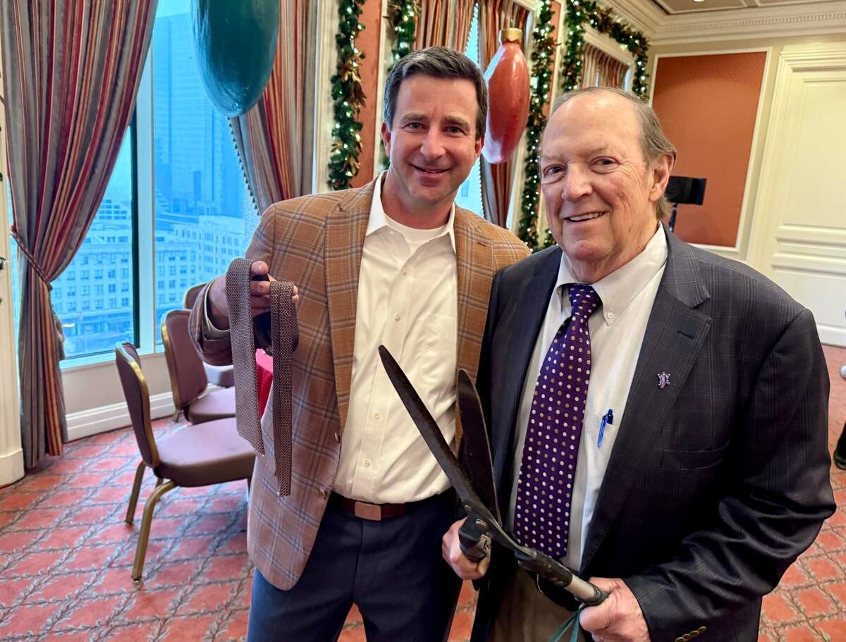 Chris Semple, left, lost his tie to emcee and shears operator Bill Landreth in a prank at the annual Exchange Club of Fort Worth holiday party at the Fort Worth Club May 4, 2024.
