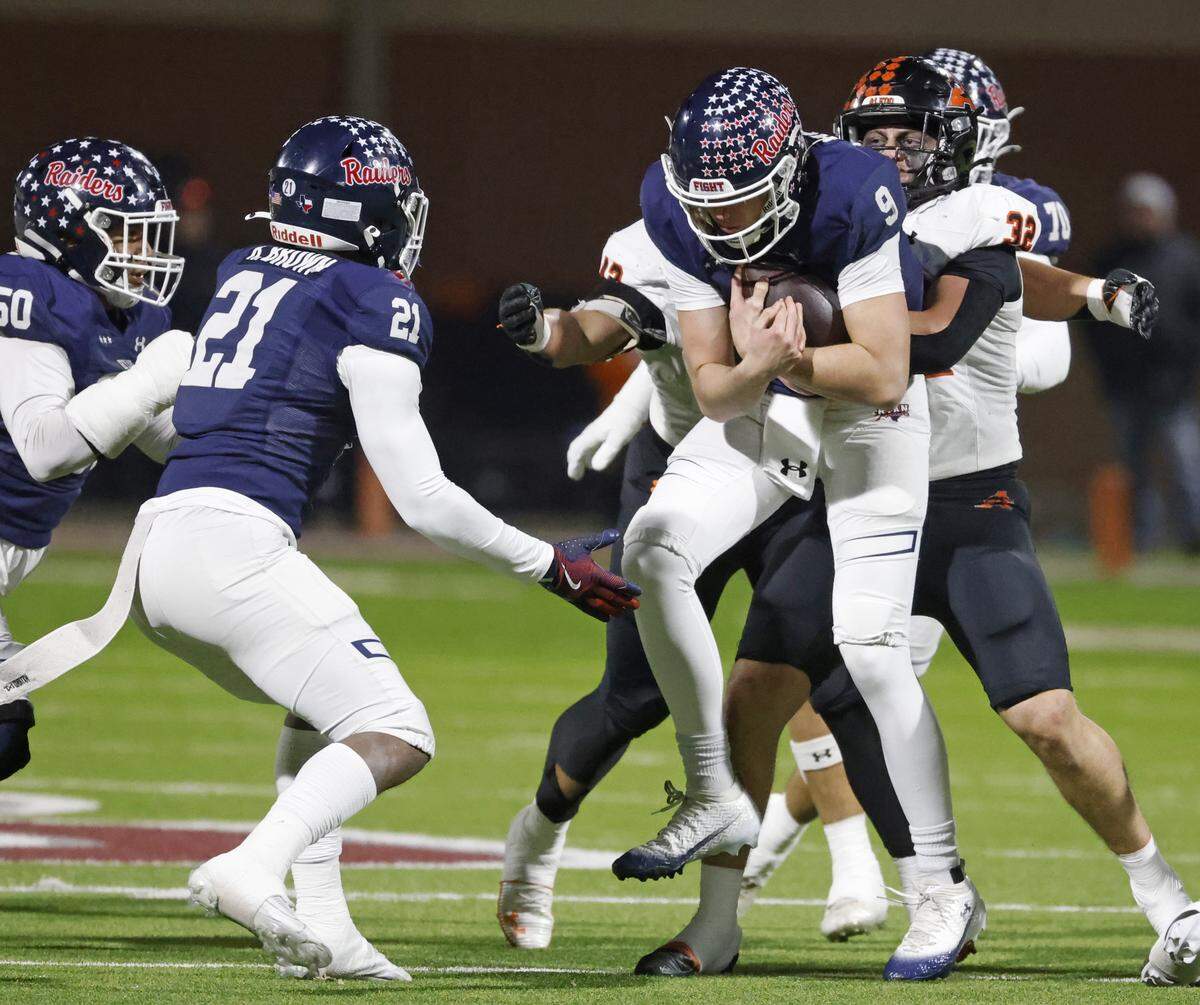 Aledo defensive end Cooper Cyphers (42) and linebacker Chase Wilburn (32) sack Denton Ryan quarterback Quin Henigan (9) for a four yard loss during the first half of a UIL Class 5A Division I Quarterfinal on Friday Dec. 05, 2025 at Northwest ISD Stadium in Fort Worth, Texas.