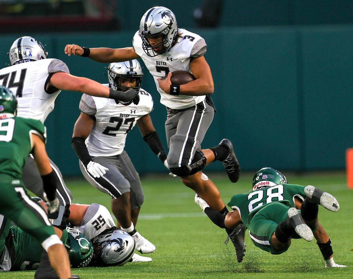 Denton Guyer quarterback Eli Stowers (3) hops over Arlington linebacker Louis Alexander (28) for a short gain during the second half of the 6A Division II Area round high school football playoffs, December 19, 2020, played at Globe Life Park in Arlington, Tx. (Steve Nurenberg Special to the Star-Telegram)