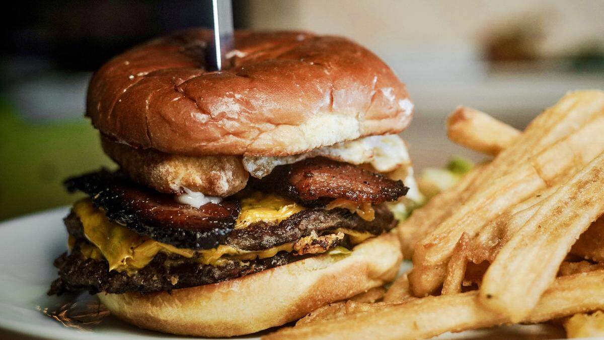 A double cheddarburger with smoked bacon, a fried egg, jalapenos and caramelized onion at Rex’s Bar & Grill.